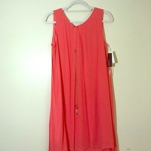 The dress is a coral color zipped down back